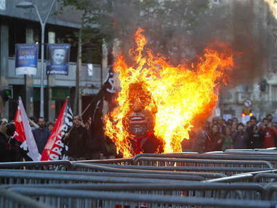 Un mueco de papel que simulaba ser el presidente del Gobierno es quemado durante la manifestacin. EFE